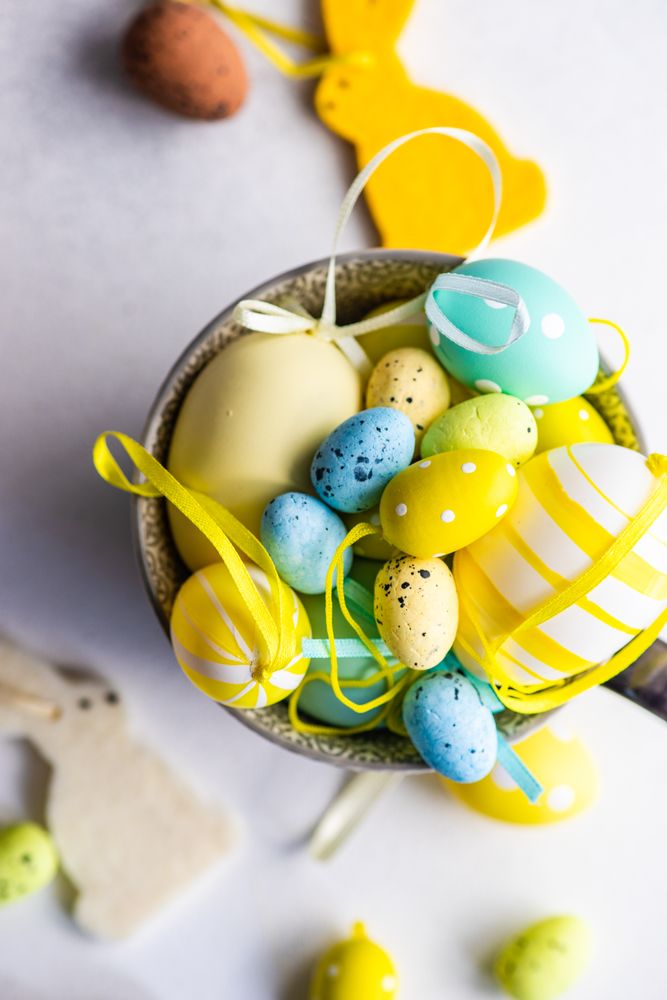 Top view of bowl of decorative eggs with rabbit ornaments