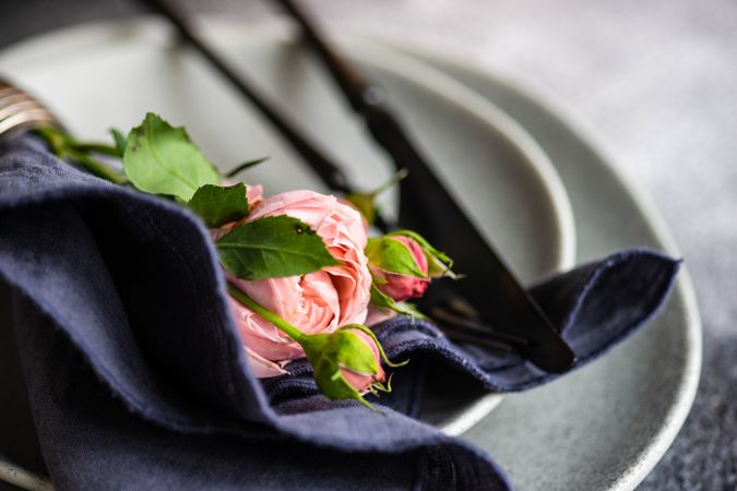 Pink flowers on grey plate with navy napkin