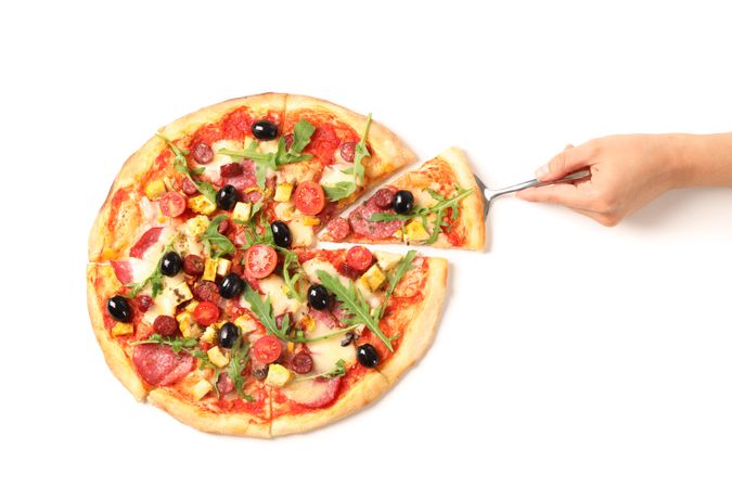 Female hand takes a piece of pizza, isolated on plain background