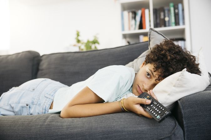Girl watching tv in living room