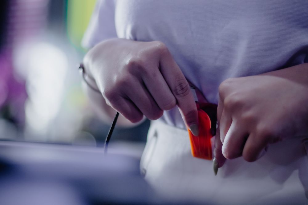Intricate focus showcasing a hand carefully adjusting a cable