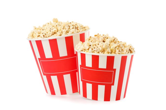 Striped buckets with popcorn isolated on plain background