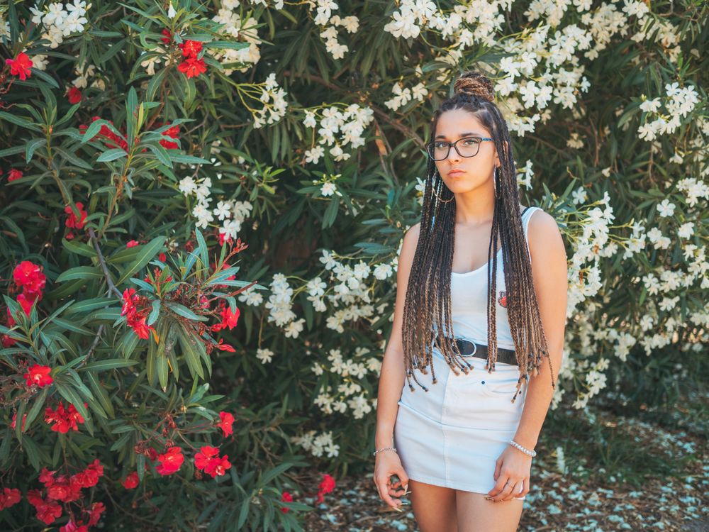 young female standing near blooming trees