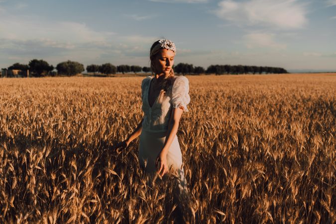 Woman in middle of wheat field