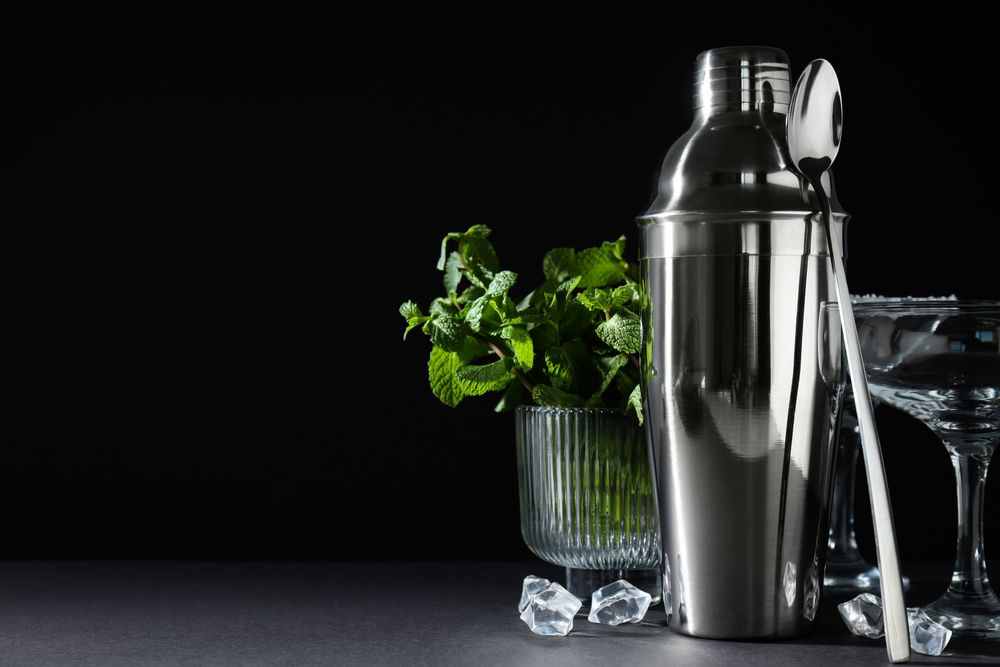 Concept of preparing cocktail, shaker, space for text