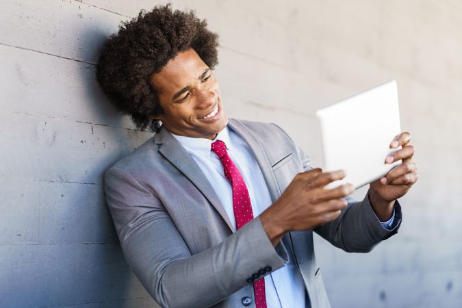 Man having a call on a tablet outside of office