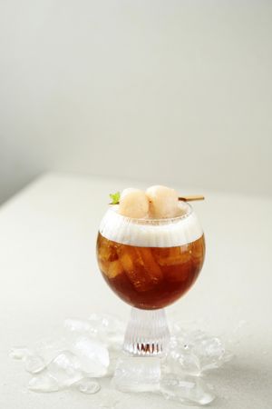 Refreshing ice tea topped with foam and lychee balls