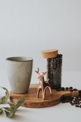 Mug and decorative elements on wooden stand on table