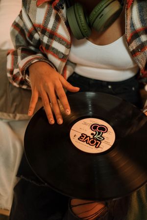 Cropped image of woman holding vinyl record
