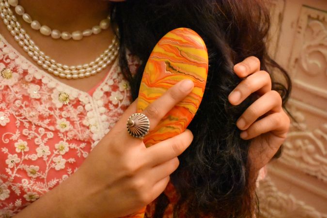 Close-up shot of woman brushing her hair