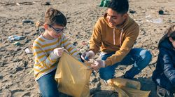 Young volunteers cleaning the beach