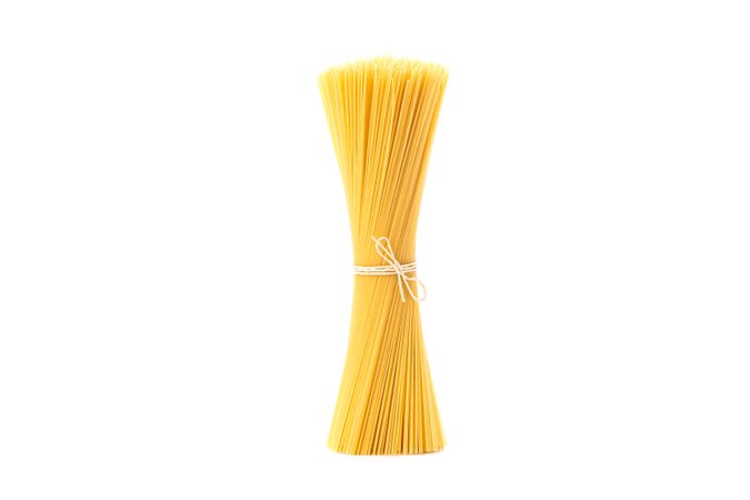 Pasta isolated on bright background. Uncooked whole wheat pasta