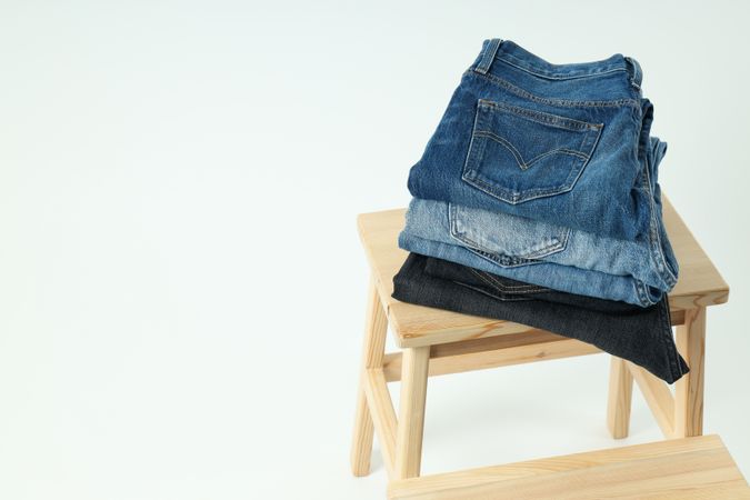Folded jeans on a wooden chair