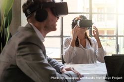 Two entrepreneurs having a metaverse remote meeting using VR googles 49mB6B