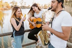Drunk woman listening to friends playing musical instruments