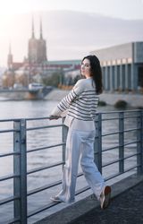 Young woman in trendy summer  clothes at sunset