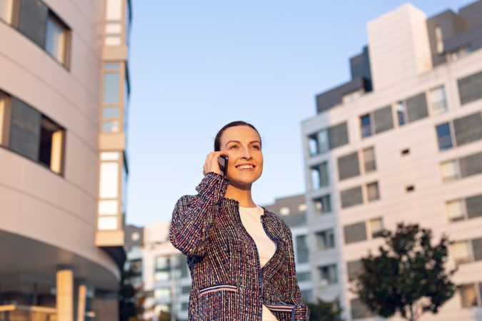 Smiling businesswoman answering phone call