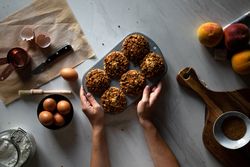 Faceless person cooking muffins with nuts