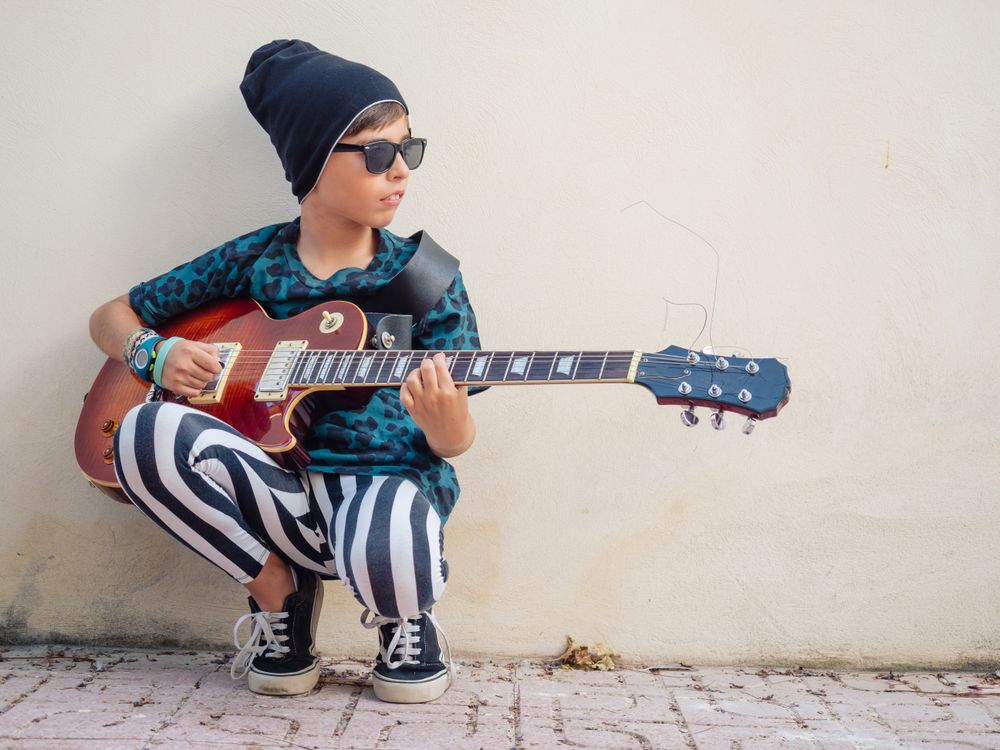 Energetic kid holding guitar