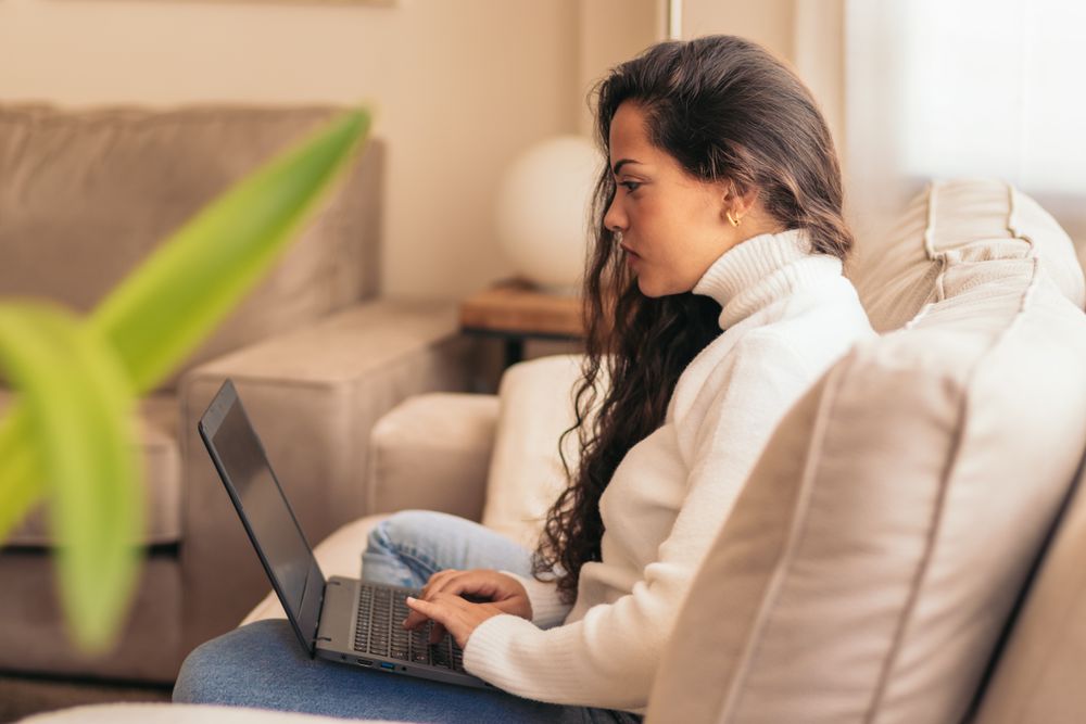 Home Productivity: Young Woman Working on Laptop