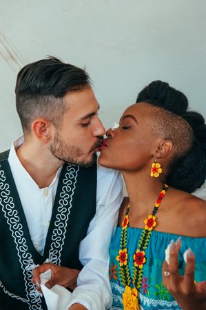 Mexican-American groom and Zulu bride kiss