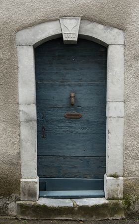 Building with blue door and flowers on steps