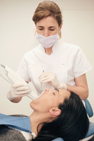 Professional orthodontist doing digital 3D teeth cast in dentist office