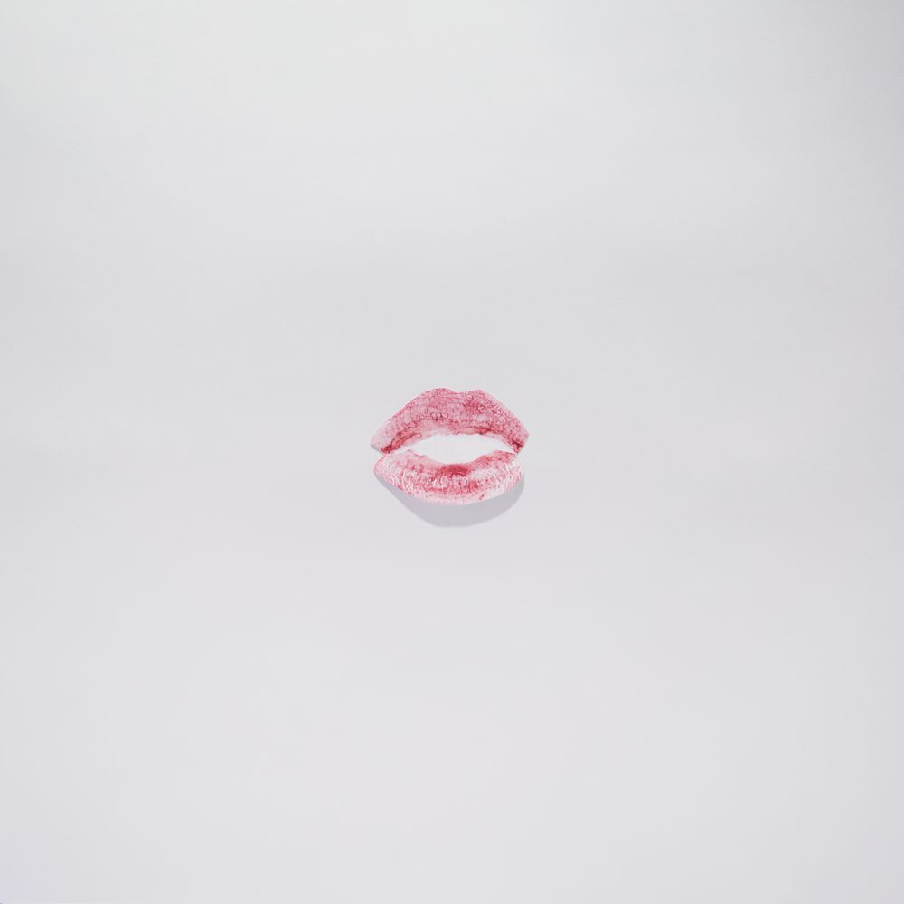 Kiss with lips red on a plain background