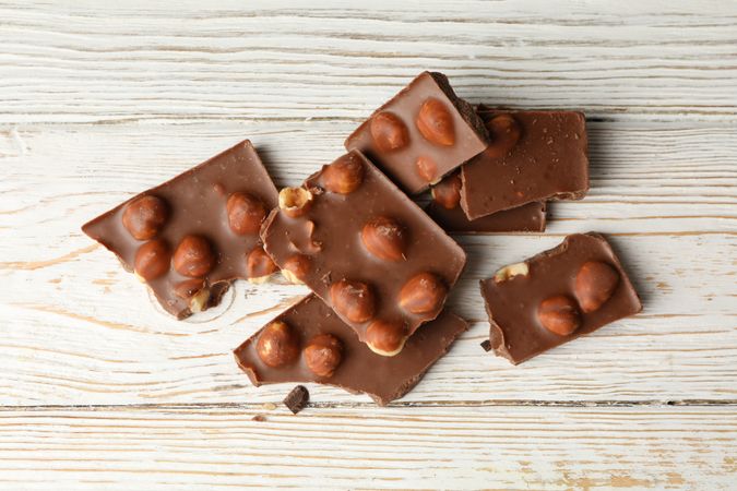 Tasty chocolate pieces on wooden table