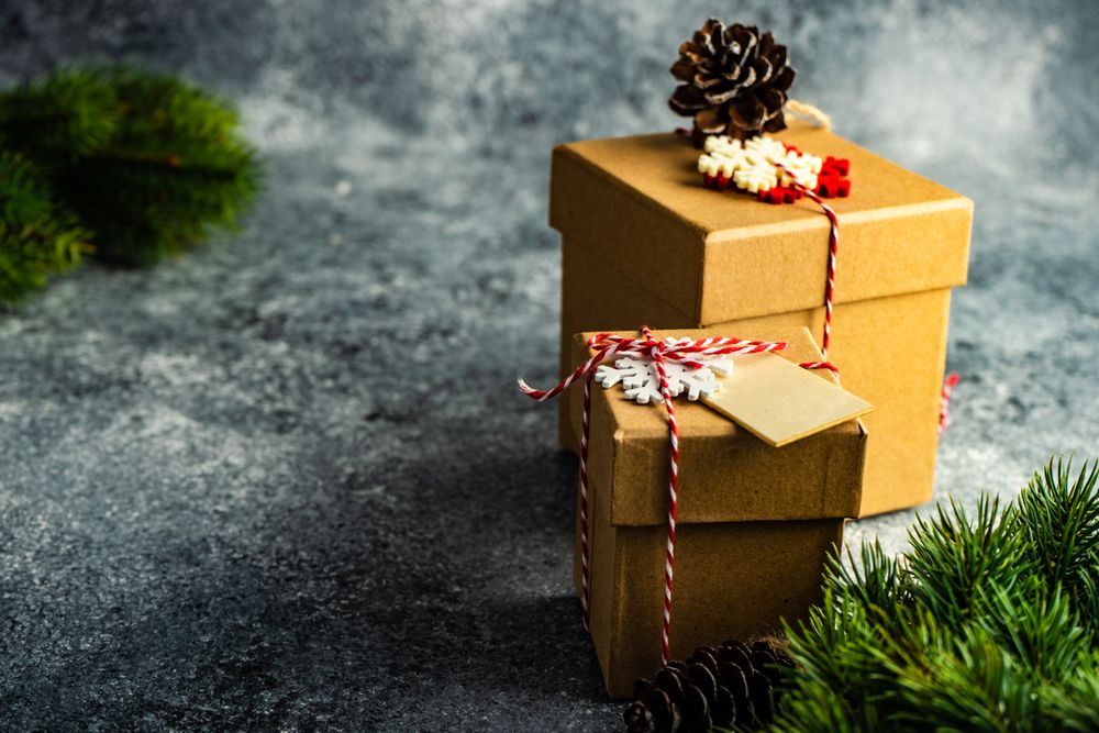 Two Christmas presents wrapped with decorative snowflakes
