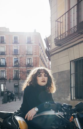 Young woman in custom motorbike