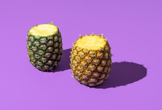 Pineapple fruit in bright light minimalist on a purple background