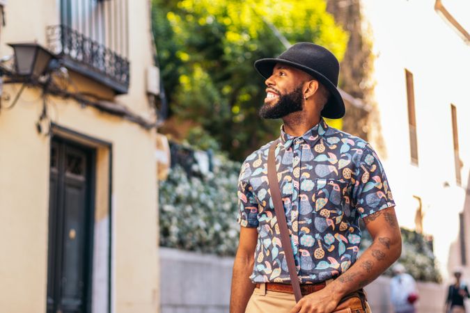 Stylish Black man walking on the city street