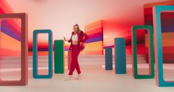 Professional Female Performer Energetically Rehearsing a Modern Dance Choreography in a Colorful Studio. Stylish Woman Looking at the Camera and Dancing Expressively, Practicing Her Routine.