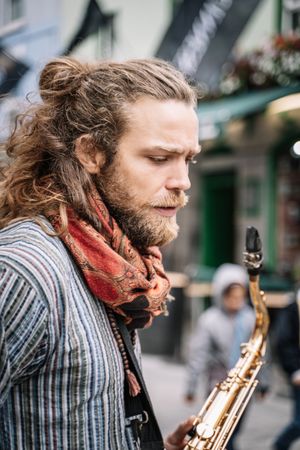 Portrait of male saxophonist in the street