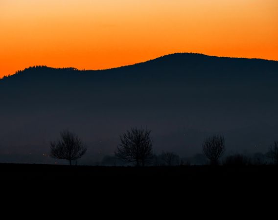 Silhouettes of mountains and colorful amazing sunset in Alsace