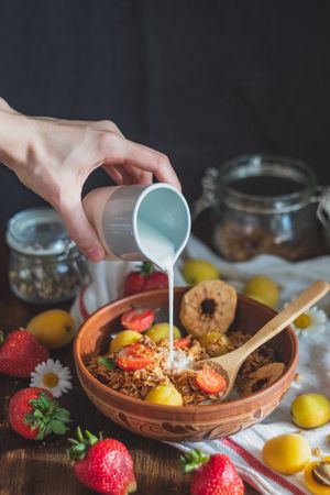 Granola bowl with fresh milk and fruit