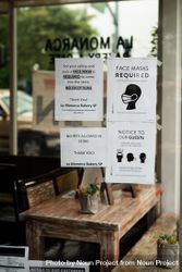 Signs in coffee shop requiring masks and social distancing 48ByZ0