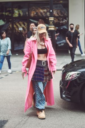 London, England, United Kingdom - September 18 2021: Woman in pattern jeans and pink trench