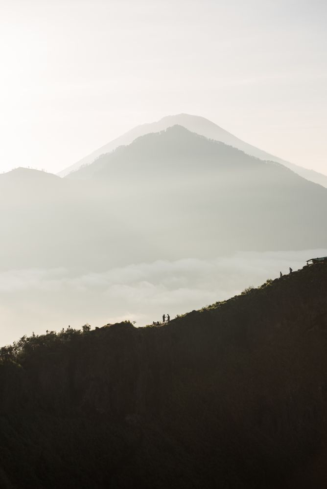 Silhouette of mountain under cloudy sky