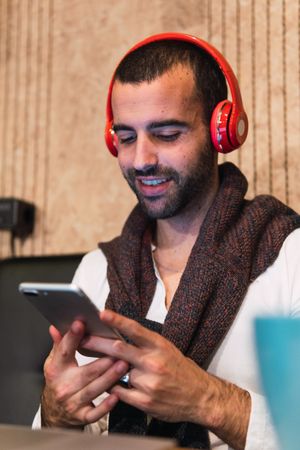 Male freelancer browsing on mobile phone