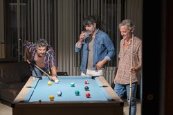 Group of men playing pool together