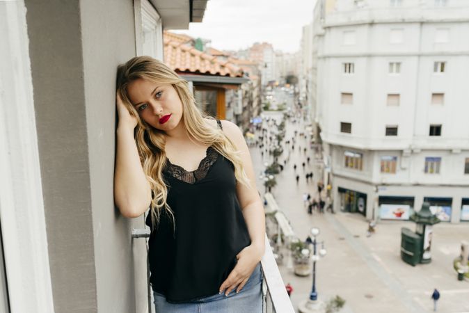 Young woman looking at camera on balcony