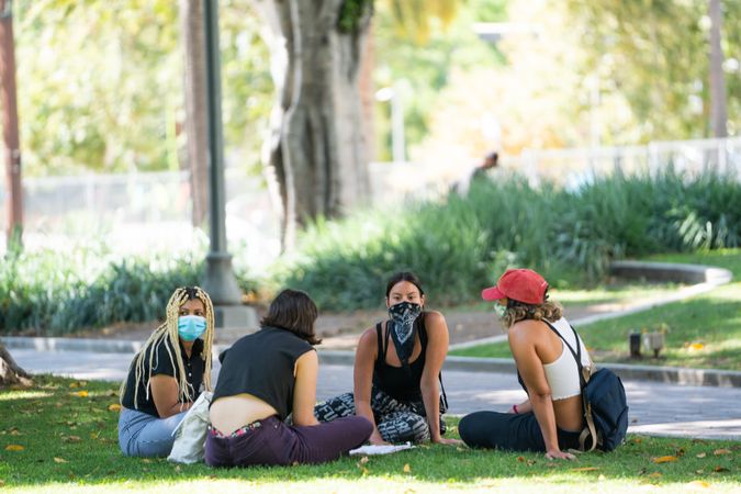 Los Angeles, CA, USA — June 16th, 2020: group of women sitting on grass at rally in discussion