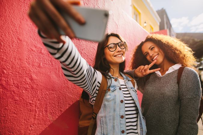 Youthful friends taking selfie for social media
