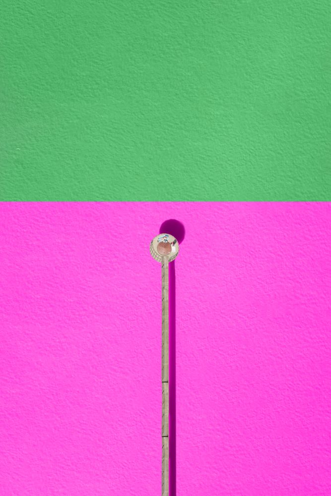 Minimalistic composition of a woman resting in a structure in the lake