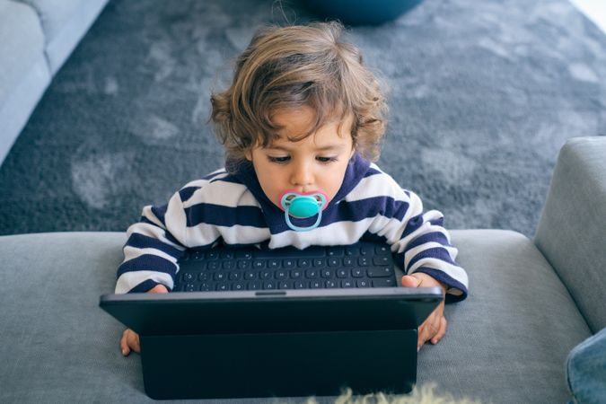 Little boy using tablet at home