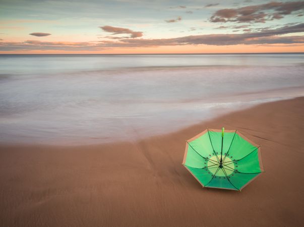 Umbrella on beach near sea
