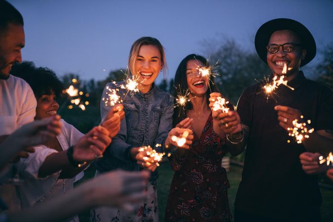 Group of friends playing with sparklers