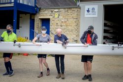 Older people walking boat to the water for rowing
